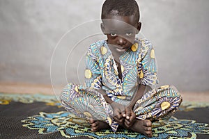 Sad little African boy Looking at Camera with Blurred Background