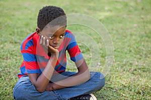 Sad little boy in the park