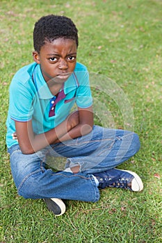 Sad little boy in the park