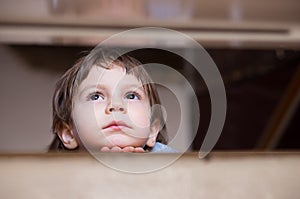 Sad little boy thinking looking up