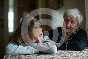A little girl is comforted by her grandmother photo