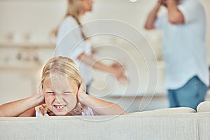 Sad little girl covering her ears with parents fighting in the background. Depressed child, parents arguing at home