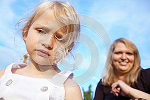 Sad little girl and her mother