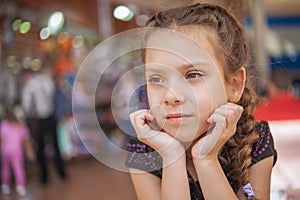 Sad little girl in market