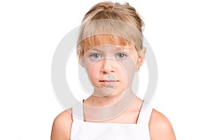 Sad little girl with serious face on white