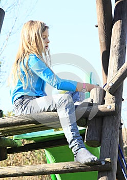 Sad little girl on a slide