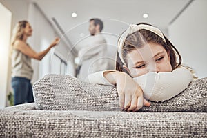 Sad little girl, sofa and parents in conflict, disagreement or fight in the living room at home. Family, divorce and