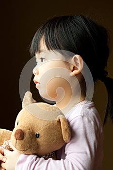 Sad little girl with teddy bear