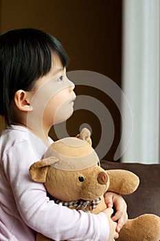 Sad little girl with teddy bear