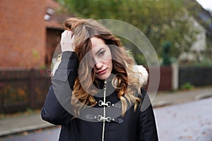 Sad lonely depressed young woman ruffling her hair photo