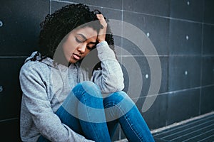 Sad and lonely girl portrait in the urban street