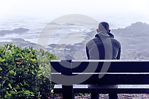 Sad and lonely man sitting on bench