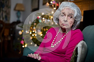 Sad And Lonely Senior Woman Unhappy About Spending Christmas At Home Alone