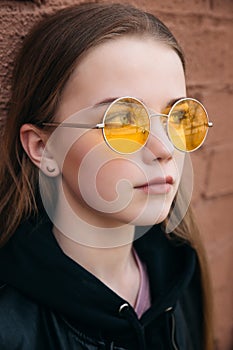 Sad and lonely teenager portrait in the city street