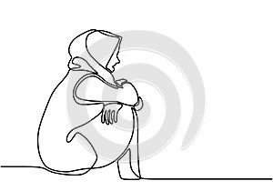 Sad and lonely woman. Muslim girl sitting alone, holding her knee with an empty view. Expression very desperate and anxiety. Seen