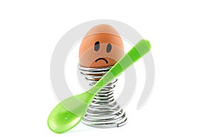 Sad looking egg in egg cup with spoon