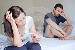 Sad lovers couple after pregnancy test result photo