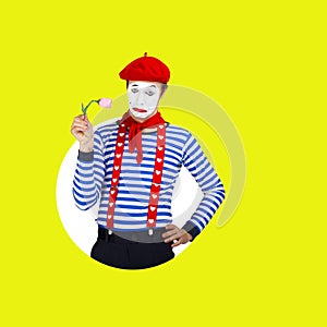 Sad male mime with flowers.Funny actor in red