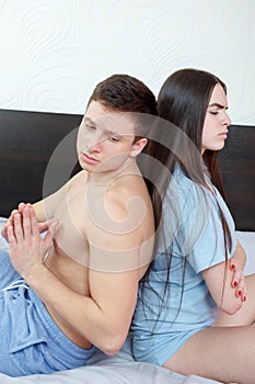Sad man beging his wife to forgive him mistake photo