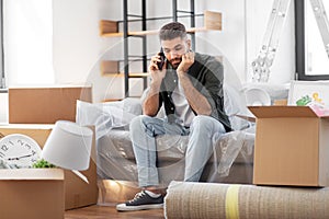 sad man calling on smartphone moving to new home
