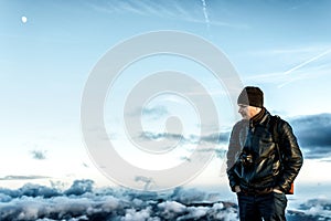 Sad man with camera on peak looking down