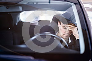 Sad man in car. Accident in traffic. Tired sleepy driver. Sick with headache or migraine. Anxiety, stress, despair or depression.