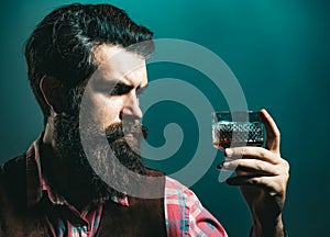 Sad man with depression looking in camera. Drunk man holding whisky glass after he drank a lot of alcohol and feeling