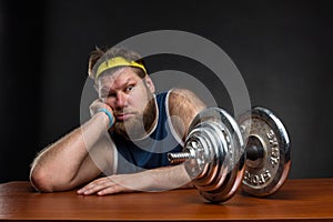 Sad man with a dumbbell