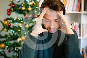 Sad man feeling negative emotions and alone during christmas
