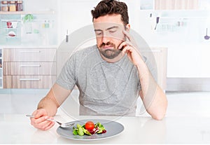 Sad man forced to eat salad for weight loss