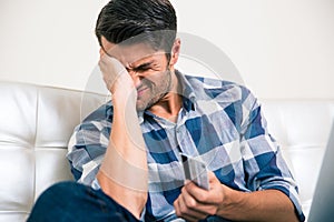 Sad man holding bank card