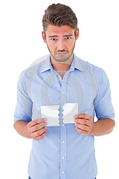 Sad man holding a broken card