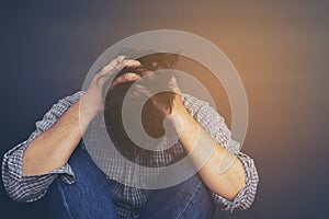 Sad man holding head with hand