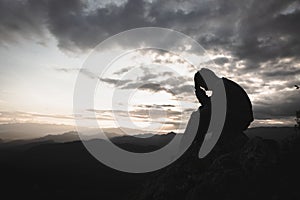 Sad man silhouette worried on the mountain. Drug addiction, failure concept