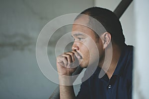 Sad man sitting in dark room. Depression and anxiety disorder concept