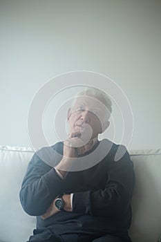 Sad man sitting on the sofa