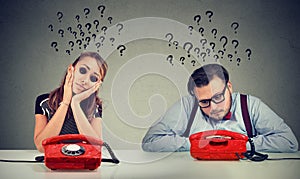 Sad man and woman waiting for a phone call from each other have many questions