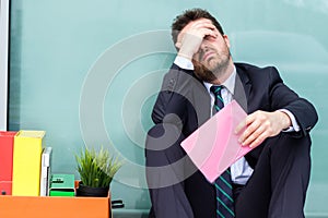 Sad manager after reading downsize notice pink slip