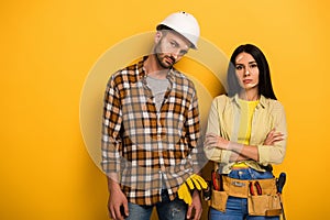 Sad manual workers with crossed arms