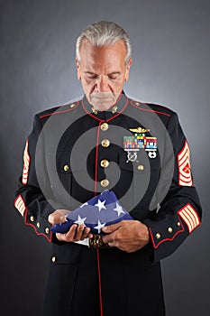Sad Marine Holding a Flag