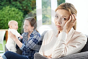 Sad Mature Woman Jealous Of Mother With Young Baby