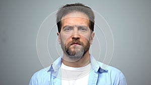 Sad middle-aged man looking into camera, unemployment, social insecurity