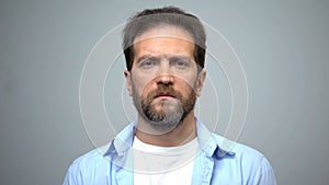 Sad middle-aged man looking into camera, unemployment, social insecurity photo
