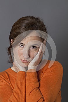 Sad middle aged woman having seasonal blues for depression