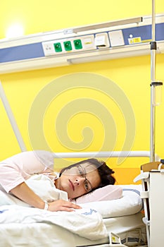 Sad middle-aged woman lying in hospital