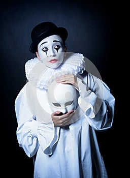 Sad mime Pierrot with a mask