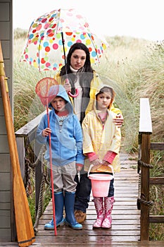 Sad mother and children on beach