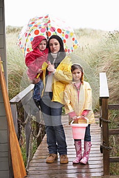 Sad mother and children on beach