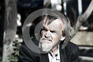 Sad homeless old man