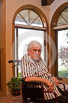 Sad old man in wheelchair